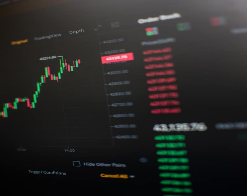 Trading dashboard with candlestick chart and stacked price list on the right, showing market data and depth indicators