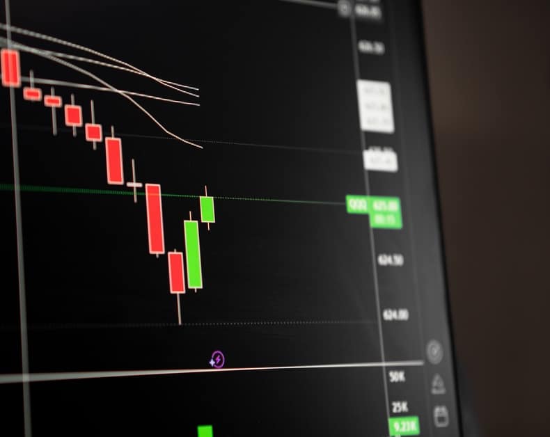 Close-up of a stock trading chart with red and green candlesticks on a dark background